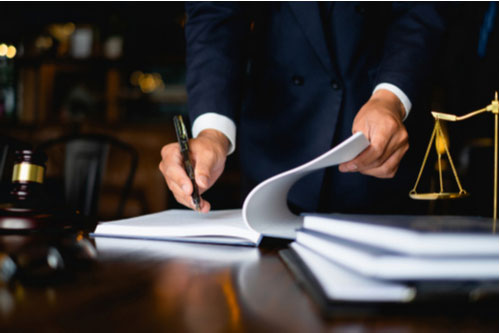 Post-trial motions lawyer writing on documents