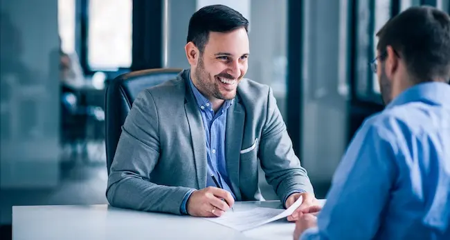 Clients and lawyers discussing personal injury case strategy and timeline expectations during initial legal consultation meeting.