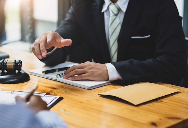 An attorney is explaining legal process delays and procedural complications affecting the client's case outcome and settlement timeline.